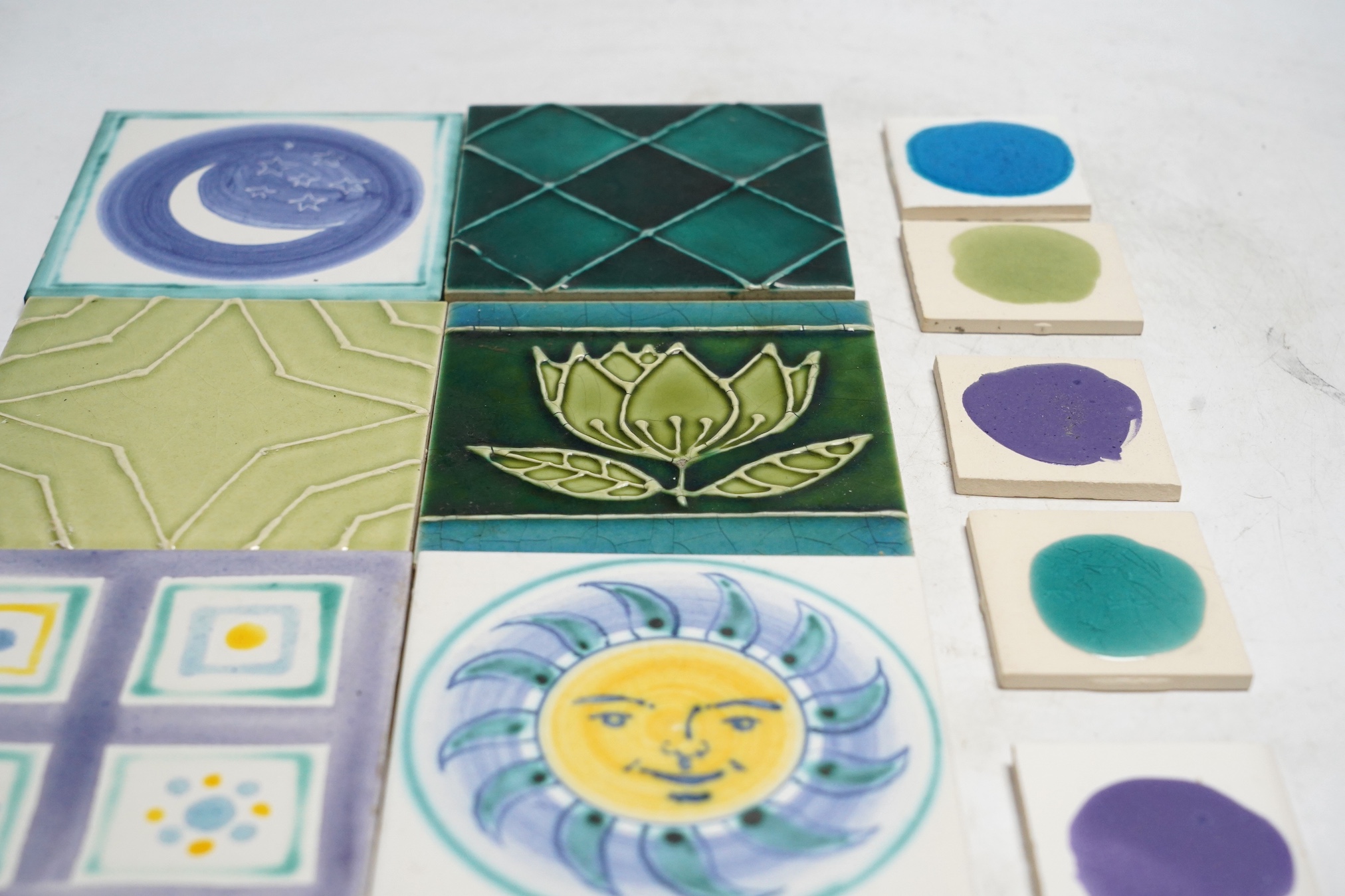 A collection of forty-three Kenneth Clark ceramic tiles and a quantity of related smaller spacer tiles, larger tiles 10x10cm